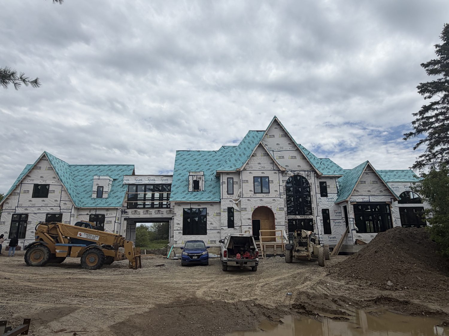 Front framing of the Brawley custom home by Danclair Construction with roof underlayment and house wrap